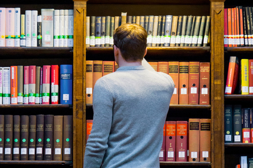 Student steht vor einem Bücherregal © Universität Wien / Alexander Schuppich